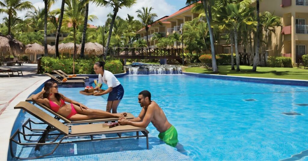 destination wedding guests relaxing at the pool at an all-inclusive resort in Punta Cana Dominican Republic