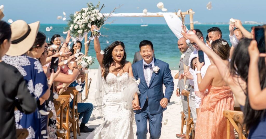 destination wedding couple celebrating with guests at an all-inclusive resort in Cancun Mexico