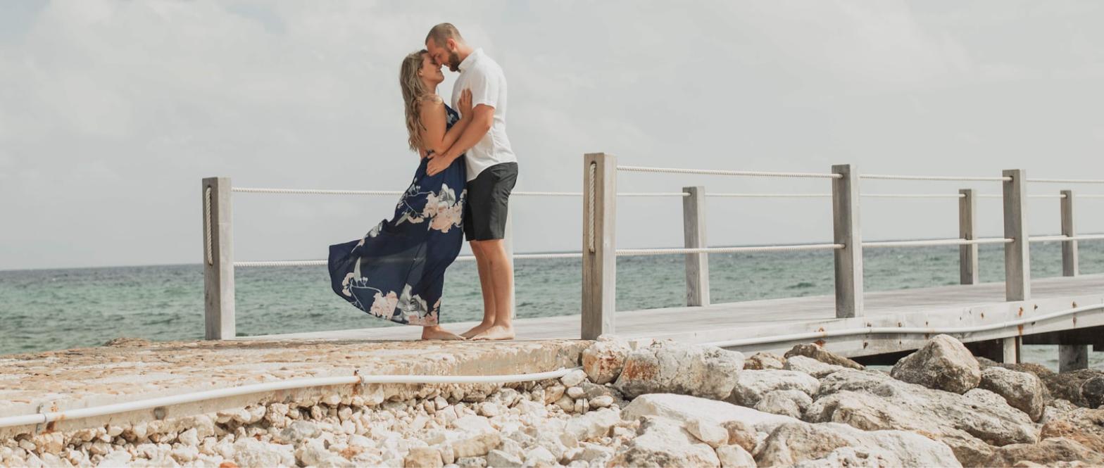 Best all-inclusive resorts for a destination wedding in Jamaica - couple embracing oceanfront